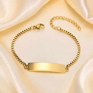 Polished gold box chain bracelet featuring a customizable rectangular ID plate on silk