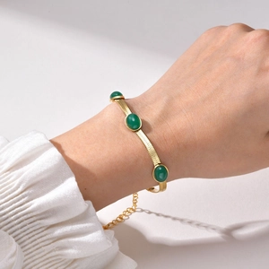 Elegant gold-plated snake chain bracelet featuring three oval green emerald zircons for women
