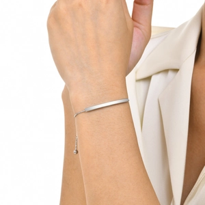 Minimalist stainless steel bar bracelet with adjustable beaded chain on woman's wrist