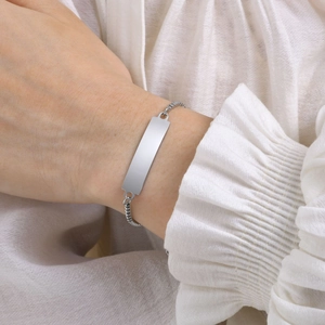 Close-up of polished silver ID bar bracelet on wrist for custom laser engraving