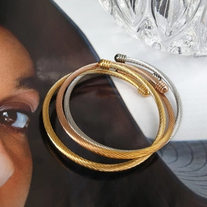 Three-piece set of twisted cable open bangles in gold, silver, and rose gold stainless steel