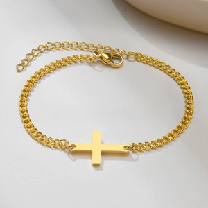Minimalist gold stainless steel curb chain bracelet featuring a horizontal cross pendant