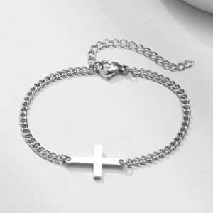 Detailed view of silver stainless steel curb chain bracelet with horizontal cross charm