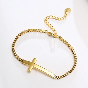 Detail of a gold stainless steel cross charm bracelet with adjustable box chain and clasp