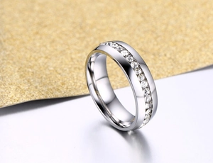 Macro shot of silver titanium ring with channel set sparkling cubic zirconia stones