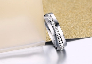 Macro detail of silver titanium steel ring featuring a row of inlaid crystal zircons