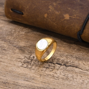 Gold stainless steel signet ring for women featuring an oval white shell inlay on top