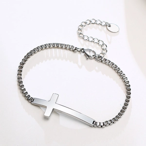 Detailed view of stainless steel box chain bracelet featuring a polished cross pendant