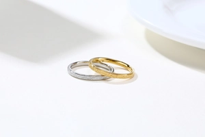 Detail of minimalist gold and silver stacked rings with fine sandblasted matte finish
