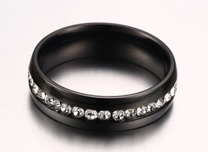 Macro detail of black stainless steel ring with inlaid sparkling zircon stones