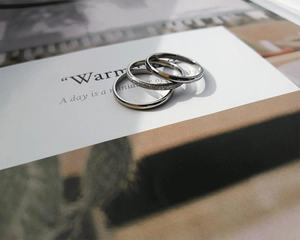 Close-up of three-piece silver stainless steel rings with polished, paved and frosted textures