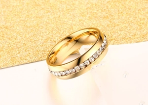 Macro view of gold plated stainless steel ring set with sparkling round cubic zirconia