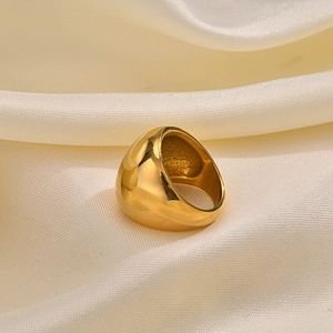 Polished chunky gold dome ring for women made of stainless steel on silk fabric