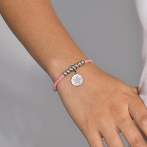 Adjustable pink leather star charm bracelet with sparkling cubic zirconia on female wrist