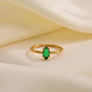 Macro detail of marquise-cut green zircon set in a gold four-prong stainless steel ring