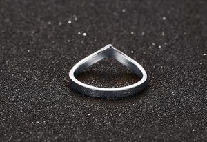 Macro shot of V-shaped silver titanium steel ring with matte sandblasted finish texture