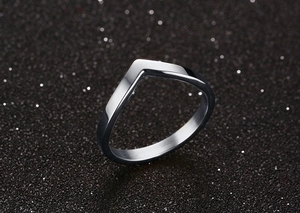 Macro shot of V-shaped silver stainless steel ring with a polished mirror finish