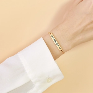 Gold stainless steel bracelet with Best Mom Ever engraving worn on a wrist