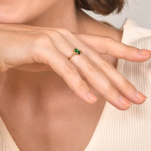 Detailed close-up of a marquise cut green zircon stone set on a golden stainless steel ring