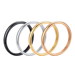 Set of four minimalist stainless steel rings in black, gold, silver, and rose gold