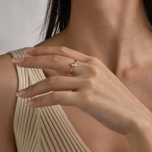 Close-up of a pear-cut zircon ring in 18K gold plating worn on a finger