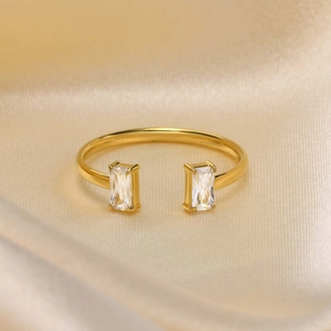 Detail of 18K gold-plated open ring featuring dual rectangular cubic zirconia stones