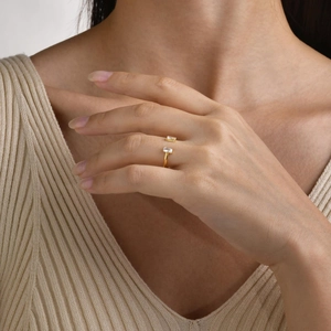 Close-up of 18K gold-plated open ring with baguette-cut white zircons on hand