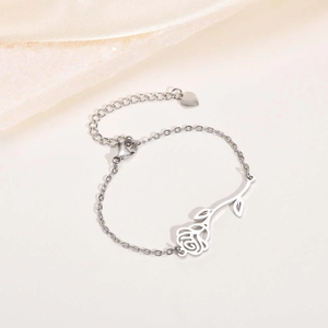 Detailed shot of silver hollow rose bracelet with heart charm and lobster clasp closure