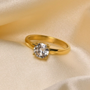 Macro detail of 18K gold ring with large round zircon in a secure 4-prong setting