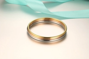 Detailed view of tricolor interlocking metal rings with elegant luxury silk ribbon
