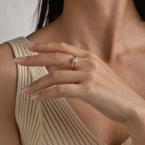 Macro shot of 18K gold plated ring with a square cubic zirconia on a model hand
