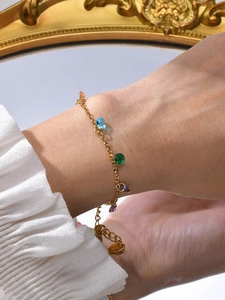 Gold plated stainless steel bracelet with seven colorful zircons on a delicate chain