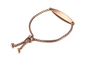 Macro detail of rose gold adjustable box chain bracelet with curved rectangular metal plate