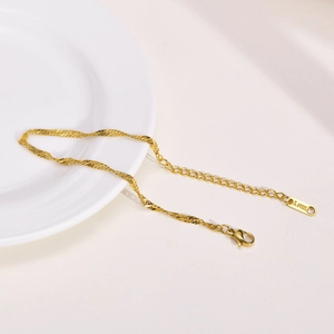 Detail of golden stainless steel twist chain with secure lobster clasp and tail tag