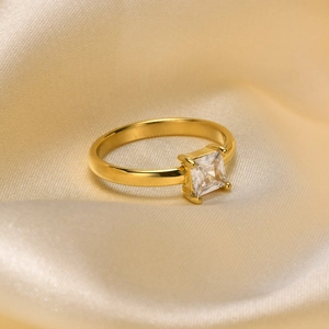 Macro shot of 18K gold plated ring with a square-cut white zircon in a 4-prong setting