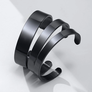 Three-piece set of polished black stainless steel open bangles in different widths