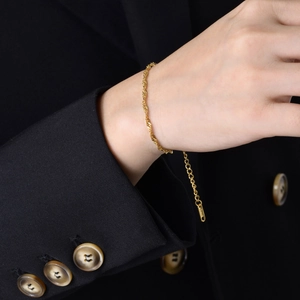 Detail of adjustable gold stainless steel water wave chain with metal logo tag