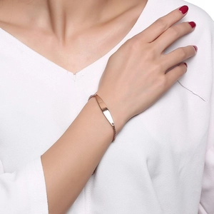 Close-up of a minimalist rose gold curved bar bracelet worn by a model for a chic look