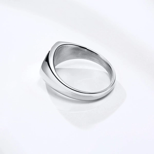 Close-up of polished stainless steel oval signet ring featuring a smooth mirror finish