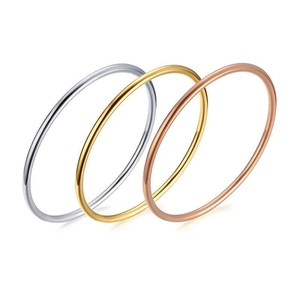 Minimalist polished stainless steel ring set in gold, silver, and rose gold colors