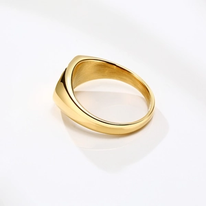 Detailed close-up of golden wide band ring with high-polish finish and brushed metal interior