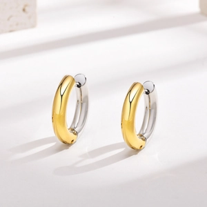 Detailed view of two-tone gold and silver polished stainless steel hoop earrings