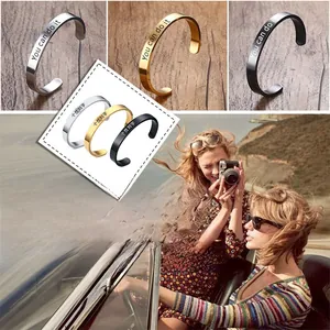 Detail of personalized stainless steel bangles with custom engraving in three colors