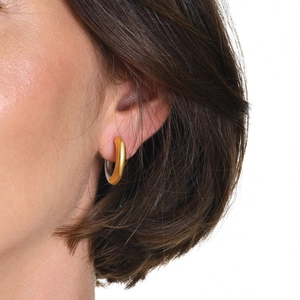 Minimalist two-tone C-shape hoop earrings in gold and silver finish worn by a model