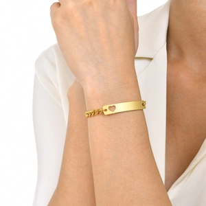 Minimalist gold heart cutout rectangular bar bracelet worn on wrist for daily styling