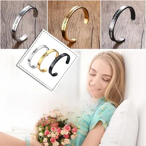 Detailed engraving showing 'Keep your style and keep trying' on C-shaped steel bangles