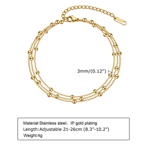 Detailed macro view of triple-layered 3mm gold bead anklet with adjustable lobster clasp