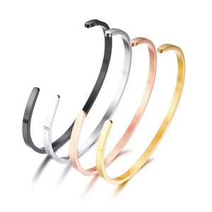 Minimalist C-shaped stainless steel bangle set in black, silver, rose gold, and gold finishes