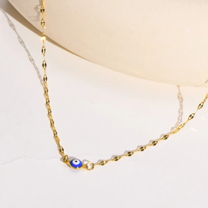 Golden stainless steel fine chain necklace with blue and white evil eye pendant on stone