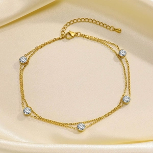 Detail of double-layer gold stainless steel anklet with five clear round zircon stones